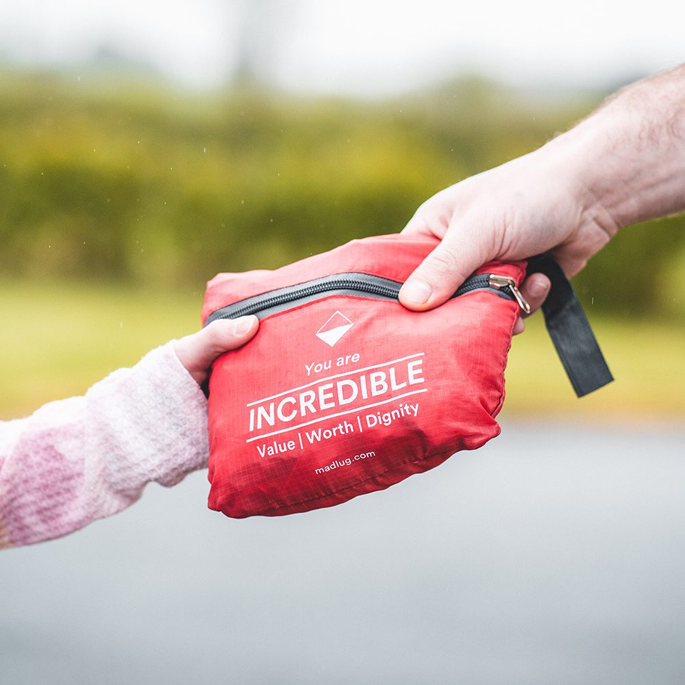 Adult and child holding a red request a bag