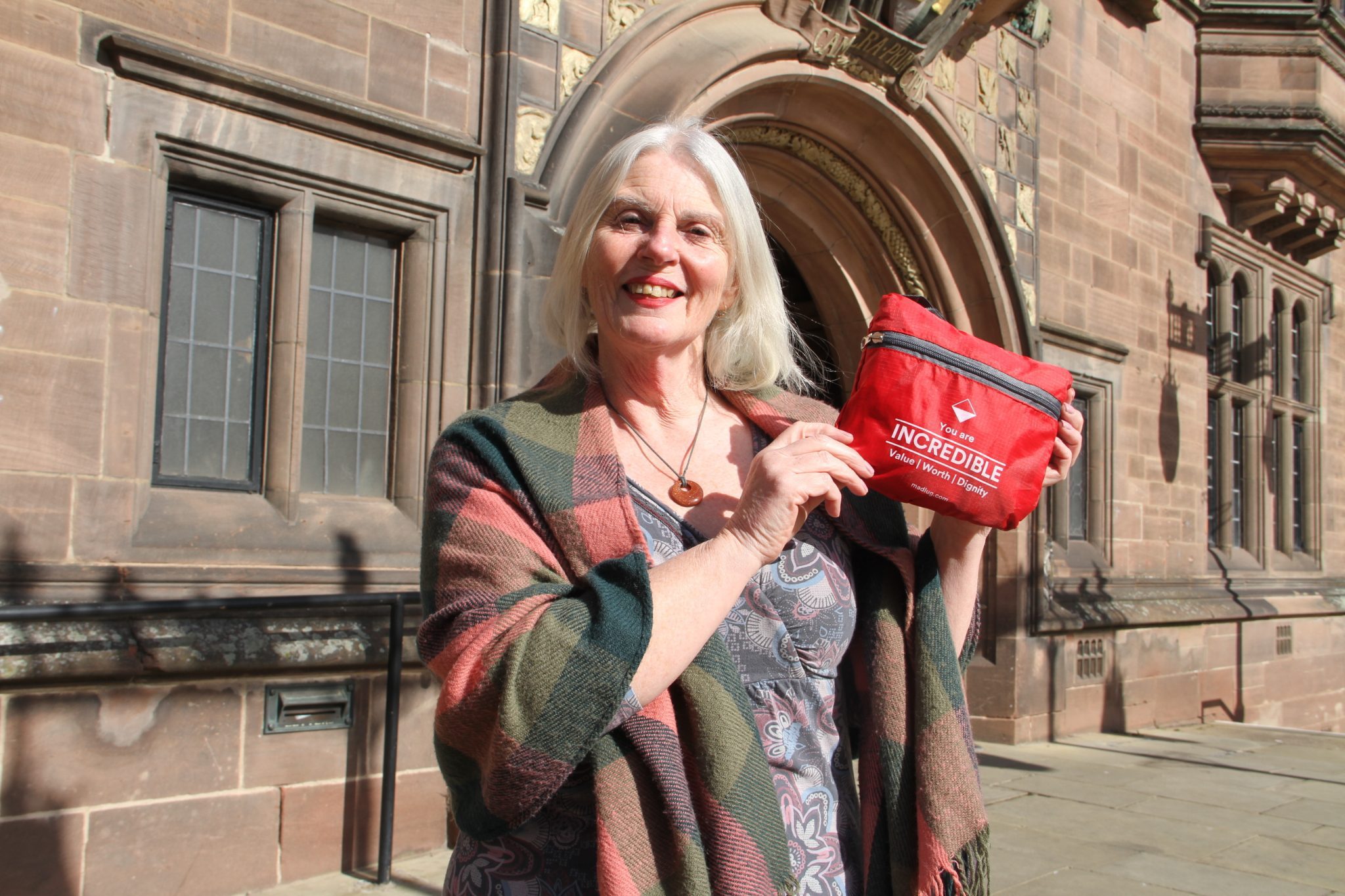 Adult and child holding a red request a bag